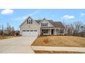Well-maintained home featuring a covered porch and a two-car garage at 1119 Brookfield Dr, Gibsonville, NC 27249