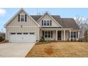 Well-maintained home featuring a covered porch and a two-car garage at 1119 Brookfield Dr, Gibsonville, NC 27249