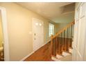 Bright foyer with hardwood floors, staircase, and a view into the living area at 116 Trinity Woods Dr, Raleigh, NC 27607
