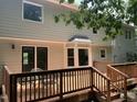 Spacious wooden deck perfect for outdoor entertaining, featuring glass doors and views of the backyard at 1210 Eastham Dr, Apex, NC 27502