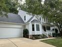 Charming two-story home with a two-car garage, manicured lawn, and traditional design elements at 1210 Eastham Dr, Apex, NC 27502