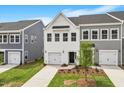 This townhome showcases well manicured landscaping, new construction and a white finish at 123 Central Townes Way # 302, Raleigh, NC 27603