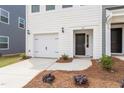 This townhome boasts a single car garage, clean white siding and a covered front porch for relaxing at 123 Central Townes Way # 302, Raleigh, NC 27603