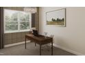 Cozy office with a chandelier, desk, comfortable chair, and large windows offering a pleasant view at 124 W Crescent Mills S Blvd # Homesite 250, Wilson's Mills, NC 27520