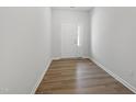 Bright and airy foyer with stylish laminate flooring and a white front door with sidelight at 127 Central Townes Way # 303, Raleigh, NC 27603