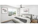 Comfortable bedroom with a large window offering scenic views and modern decor at 130 Two Hills Dr # 205B, Carrboro, NC 27510