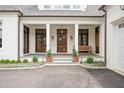 Inviting front porch with stately columns, wood doors, and bench at 1312 Duplin Rd, Raleigh, NC 27607