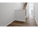 Inviting entryway featuring hardwood floors, stairs, and access to the living area at 135 Central Townes Way # 305, Raleigh, NC 27603