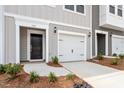 Close up of the exterior of a lovely townhome with a single car garage at 135 Central Townes Way # 305, Raleigh, NC 27603