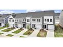 A row of new two-story townhouses, each with a garage and manicured front yard at 139 Central Townes Way # 306, Raleigh, NC 27603