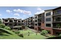 Exterior showcases modern apartments overlooking a well-maintained communal green space and manicured landscaping at 140 Two Hills Dr # 302C, Carrboro, NC 27510
