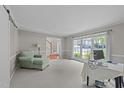 Bright living room with neutral paint, large windows, and comfortable seating at 1408 Bridgeport Dr, Raleigh, NC 27615