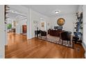 A spacious home office with hardwood floors, a modern desk and large area rug at 1412 Kings Lassiter Way, Raleigh, NC 27614