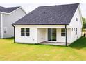 The backyard shows a covered patio with a sliding glass door and a neatly mowed lawn at 173 Little Creek Dr, Lillington, NC 27546