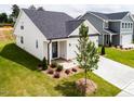 This lovely home shows a front yard featuring new landscaping and a two-car garage at 173 Little Creek Dr, Lillington, NC 27546