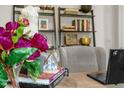 Close-up of beautifully decorated desk with purple flowers and decorative books at 180 Babbling Creek Dr, Youngsville, NC 27596