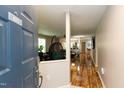Open entryway leads to a bright living space with hardwood floors and modern furnishings at 1911 Falls Landing Dr # 103, Raleigh, NC 27614