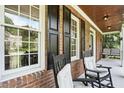 Inviting front porch featuring rocking chairs and windows, perfect for relaxing and enjoying the outdoor views at 2328 Forestbluff Dr, Fuquay Varina, NC 27526