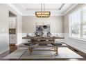 Elegant dining room with modern lighting, stylish furniture, and refined wall decor at 2527 Sidewinder Ct, Apex, NC 27523