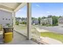 Cozy front porch with white railings and columns, offering a peaceful view of the neighborhood at 2527 Sidewinder Ct, Apex, NC 27523