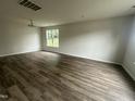 Bright living room features new hardwood floors, modern lighting, and a large window at 2852 Orchard Trace Way, Raleigh, NC 27610