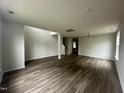 Bright living room features new hardwood floors and fresh paint with a view of the stairwell at 2852 Orchard Trace Way, Raleigh, NC 27610