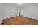 Bright bedroom with hardwood floors, white walls, built-in shelves, and a view of the backyard at 303 N Watauga Ave, Dunn, NC 28334