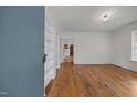 Inviting living room with hardwood floors, built-in bookshelves, and fresh paint throughout at 303 N Watauga Ave, Dunn, NC 28334