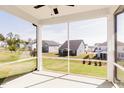 Screened porch offering serene views of the expansive backyard and surrounding neighborhood at 361 Providence Creek Dr, Fuquay Varina, NC 27526