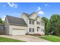 Side angle of a two-story home featuring an attached garage, blue shutters, well-kept lawn, and landscaping at 3713 Highland Creek Dr, Apex, NC 27539