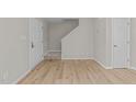 Entryway featuring modern wood flooring, neutral paint and staircase at 5012 Silverdene St, Raleigh, NC 27616