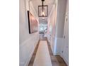 Bright hallway with paneled walls, wood-look floors, and an open view into the living area at 523 Beacon Hill Rd # 31, Lillington, NC 27546