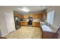 Well-lit kitchen showcasing stainless steel appliances and ample counter space at 6005 Namozine Ct, Raleigh, NC 27610