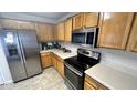 Kitchen features stainless steel appliances and light wood cabinetry at 6005 Namozine Ct, Raleigh, NC 27610