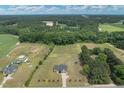 An aerial view of a sprawling home and property showcasing its landscaped grounds at 7055 Nc-242, Dunn, NC 28334