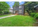 Charming two-story home with a stone walkway and well-manicured lawn at 924 W Trinity Ave, Durham, NC 27701