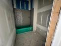 Bathroom under construction with gray subway tile, a shelf, and green tub at 1025 Coldspring Circle, Durham, NC 27705
