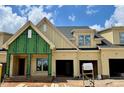 New construction townhome with yellow siding, double garage, and landscaping underway showcases modern design at 1025 Coldspring Circle, Durham, NC 27705
