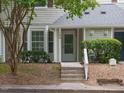 Inviting front entrance with a well-manicured lawn and gray exterior at 105 Sir Richard Ln, Chapel Hill, NC 27517