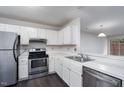 Well-lit kitchen with white cabinets, stainless steel appliances, and open design at 105 Sir Richard Ln, Chapel Hill, NC 27517