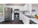 Bright kitchen featuring stainless steel appliances, white cabinetry, and modern countertops at 105 Sir Richard Ln, Chapel Hill, NC 27517