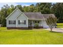 Charming single-story home with a manicured lawn and attached garage, perfect for suburban living at 106 Oak Rd, Butner, NC 27509