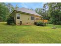 Exterior view of home featuring a wooden deck and expansive green lawn at 109 Springwood Dr, Wake Forest, NC 27587