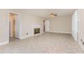 Bright living room featuring a decorative fireplace, neutral walls, and durable flooring at 1209 Bobbitt Dr, Garner, NC 27529