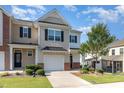 Charming townhome featuring an attached garage, a well maintained lawn and delightful front yard landscaping at 1217 Trilogy Blvd # 174, Morrisville, NC 27560
