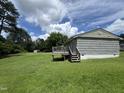 Home's exterior with a wooden deck and spacious backyard at 124 Kearney Ave, Oxford, NC 27565