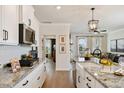 Elegant kitchen flowing into a living area, showcasing granite countertops and a stylish design at 1305 Westerland Way # 17, Durham, NC 27703