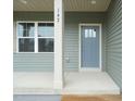Close up of the covered front porch showcasing the front door, number and window at 147 Harmony Trl, Broadway, NC 27505