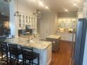 Bright kitchen featuring white cabinetry, granite countertops, stainless steel appliances, and double islands at 1512 Obrien Cir, Wake Forest, NC 27587