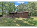 Cozy brick home with a covered front porch and well-maintained lawn, showcasing classic design at 2005 Messer Rd, Raleigh, NC 27603